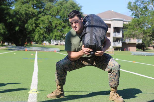 A machine gunner demonstrates a sandbag squat during the 2016 Tactical Athlete of the Year competition on Marine Corps Base Camp Lejeune, N.C.