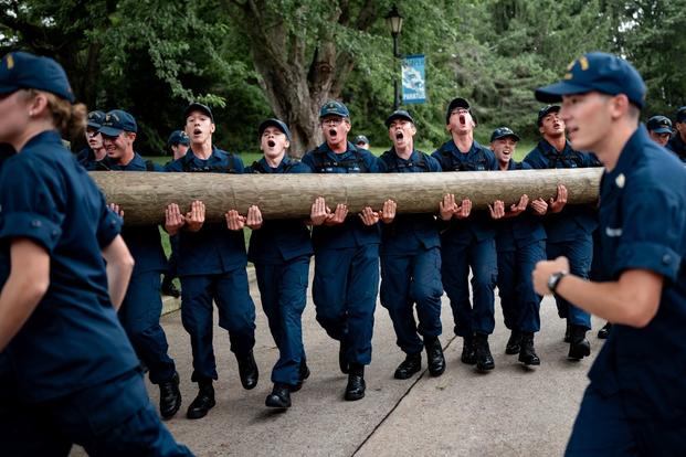 U.S. Coast Guard cadets carry a log during sea trials at the academy in New London, Connecticut.