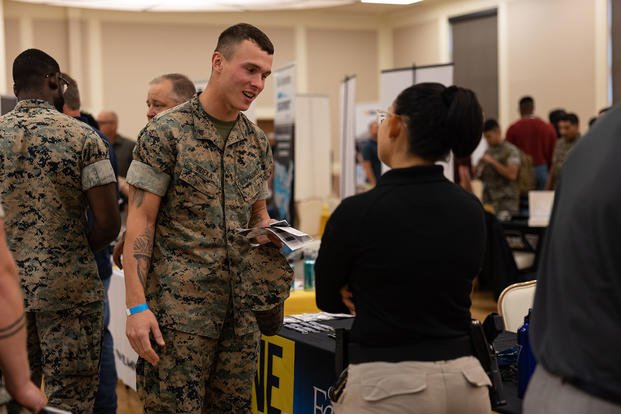 U.S. Marine Corps Cpl. Jordan Videka, left, speaks to Ciarra King, a recruiter with the Fayetteville Police Department, during the Hiring Our Heroes Skills and Trades Career Fair at Marston Pavilion on Marine Corps Base Camp Lejeune, North Carolina.