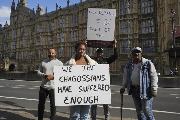 Chagossians Whitney Tranquille, center, attends a protest