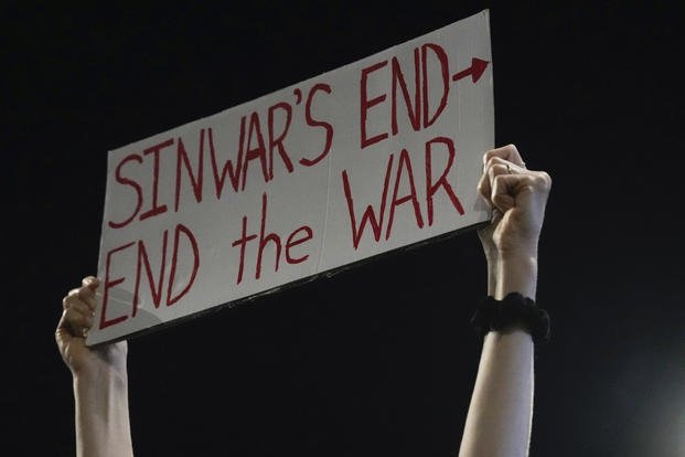 Demonstrator holds a sign about the killing of Hamas leader Yahya Sinwar