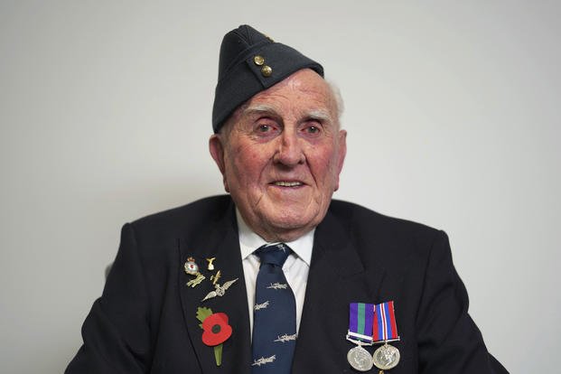 A British 100-year-old World War II veteran poses for a photograph. 