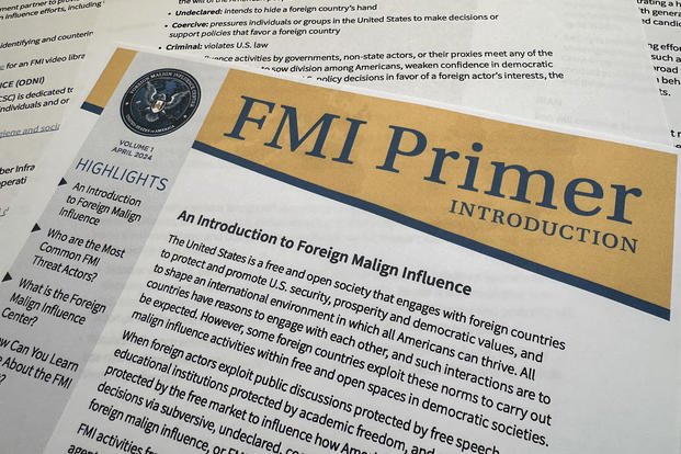 A document about the Foreign Malign Influence Center, a division of the Office of the Director of National Intelligence, is photographed June 12, 2024. Federal officials who track disinformation campaigns say they are issuing more warnings to political candidates, government officials and others targeted by foreign groups as America's adversaries seek to influence the 2024 election. (AP Photo/Jon Elswick)