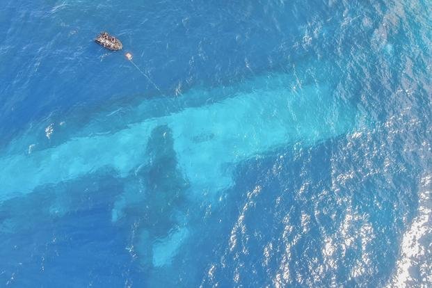 Divers survey the area around HMNZS Manawanui on the southern coast of Upulo, Samoa.