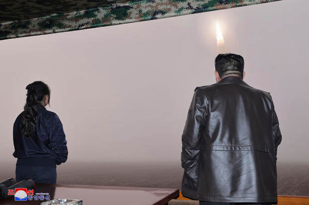  North Korean leader Kim Jong Un, right, and his daughter observe what it says is a test launch of new intercontinental ballistic missile