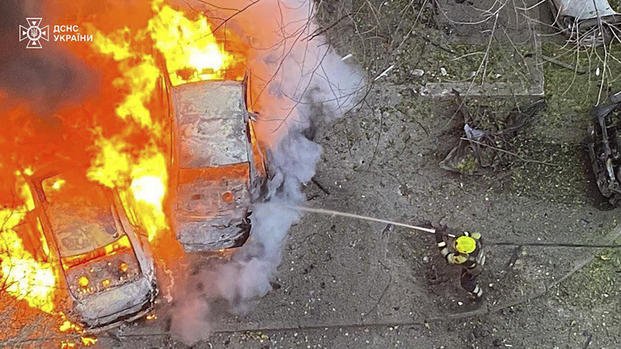 Emergency services personnel work to extinguish a fire in Ukraine.