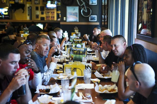 Marines with I Marine Expeditionary Force eat lunch together as part of a motorcycle ride at a local Buffalo Wild Wings in Murrieta, Calif., May 29, 2014.