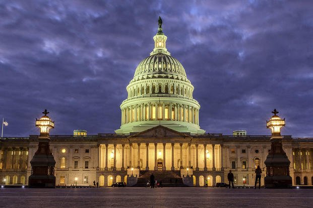 Lights shine inside the U.S. Capitol Building as night falls in Washington. 