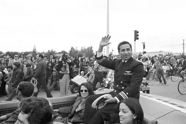 Lt. Cmdr. Everett Alvarez Jr., a former POW for 8 1/2 years in North Vietnam, waves to joyous well-wishers during a parade in his honor in his hometown of Santa Clara, Calif., March 25, 1973. 