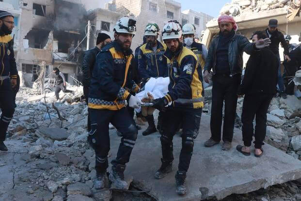 Syrian White Helmets civil defence workers carry a victim