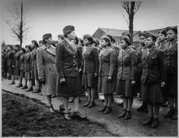 Maj. Charity E. Adams and Capt. Abbie N. Campbell inspect the first contingent of Black members of the Women’s Army Corps – the 6888 the Central Postal Directory Battalion – somewhere in England during World War II.