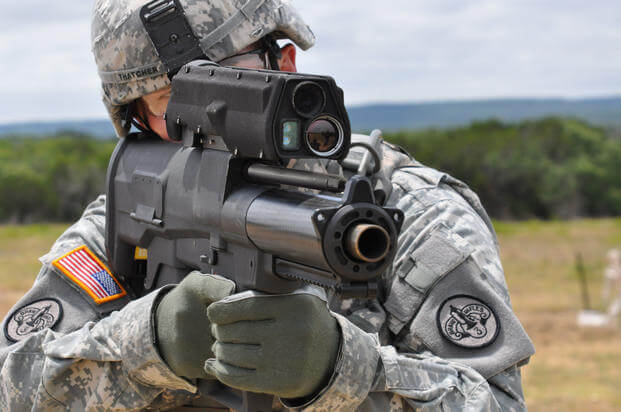 A U.S. Army soldier aims an XM-25 weapon system at Aberdeen Test Center, Maryland, in July 2009.