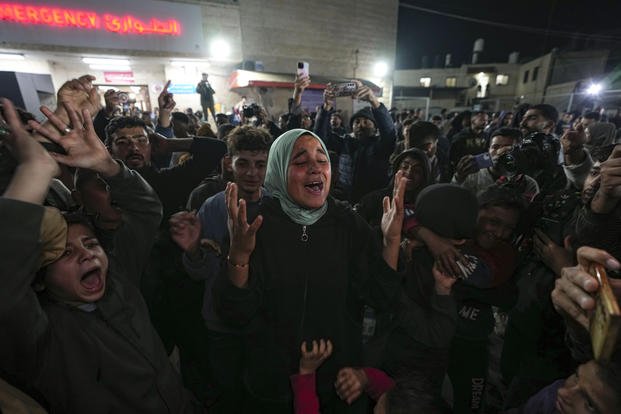 Palestinians celebrate the announcement of a ceasefire deal 