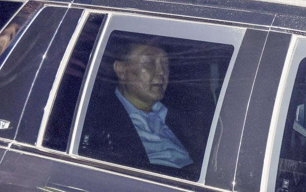 Impeached South Korean President Yoon Suk Yeol, sits in a car as he heads to a detention center