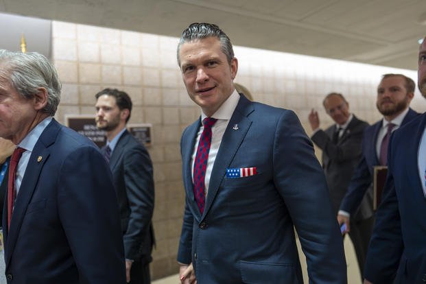 Pete Hegseth, President-elect Donald Trump's nominee to be Defense Secretary, walks