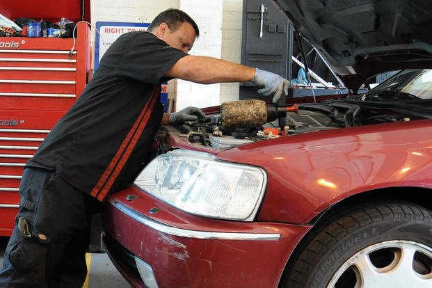 Alejandro Soto, 100th Force Support Squadron auto hobby shop technician from McFarland, Calif., adds battery water at the auto hobby shop on RAF Mildenhall, England. 