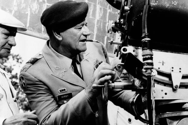 John Wayne looks through the camera to check the next set-up during filming of ‘The Green Berets’ on Nov. 17, 1967, in which he is both the star and director.