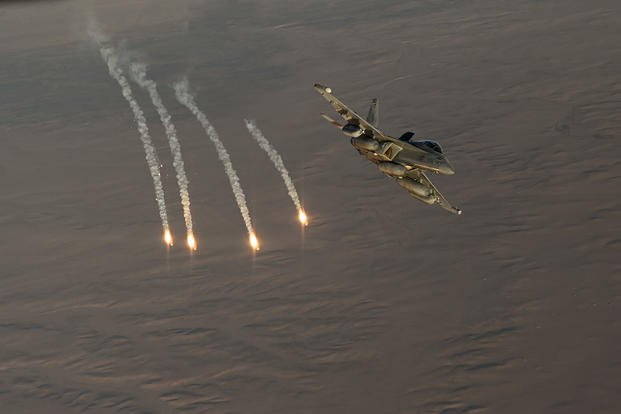 U.S. Navy EA-18G Growler fires flares during an Operation Inherent Resolve mission 