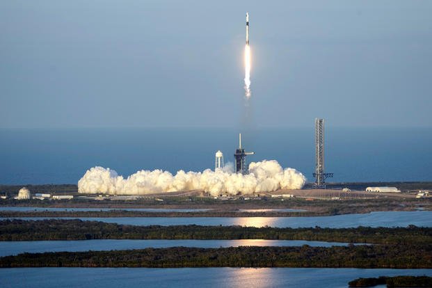  SpaceX Falcon 9 rocket, with a crew of four aboard the Crew Dragon spacecraft, lifts off