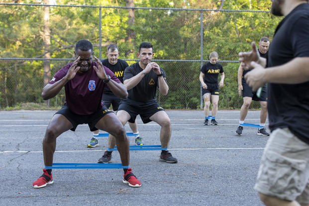 U.S. Army battalion commanders from 3rd Brigade Combat Team, 10th Mountain Division, use resistance bands to complete a leg exercise at a special physical training session at Fort Polk, Louisiana.