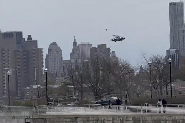In this photo taken from video, a helicopter falls from the sky into the Hudson River