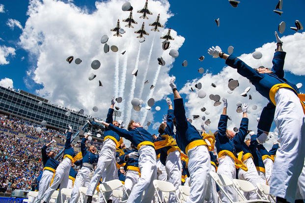 The U.S. Air Force Academy Class of 2024 graduates toss their hats