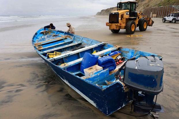 Suspected smuggling panga that overturned in the surf in Del Mar