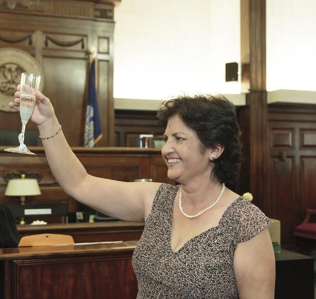 Mandonna "Donna" Kashanian, 64, holds up a champagne glass.