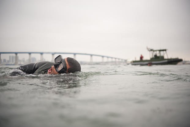 A Basic Underwater Demolition/SEAL (BUD/S) student participates in interval swim training in San Diego Bay.