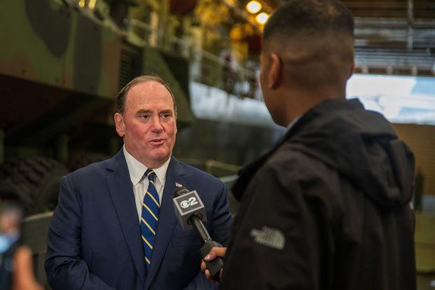 Secretary of the Navy John Phelan speaks to a local news reporter while visiting the San Antonio-class amphibious transport dock ship USS New York (LPD 21) during Fleet Week New York.