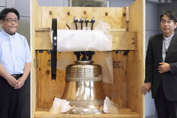 A church bell inside a shipping box.