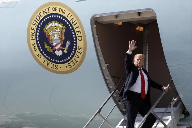 President Trump waves after greeting troops at Joint Base Elmendorf-Richardson