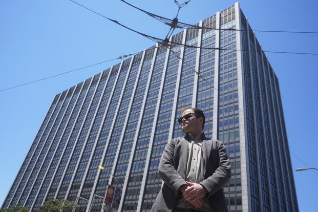 Marc Seawright poses for a photo outside of the Phillip Burton Federal Building and U.S. Courthouse in San Francisco