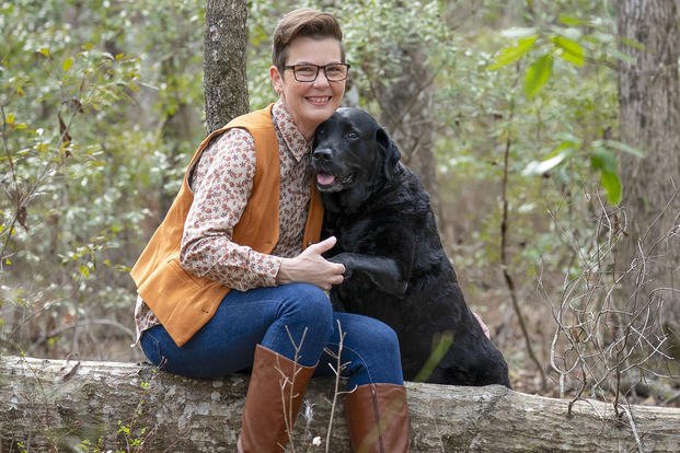 ‘After Action’ host and producer Stacy Pearsall is shown with her service dog, Charlie.