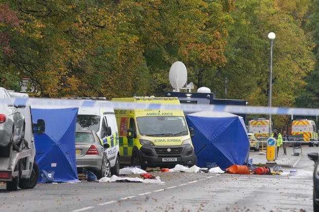 Police guard the scene of a stabbing incident at a synagogue in England.