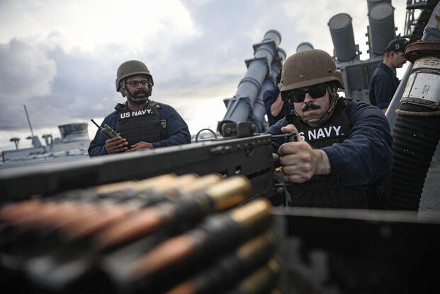 Navy Petty Officer 1st Class Brandon House fires a .50-caliber machine gun
