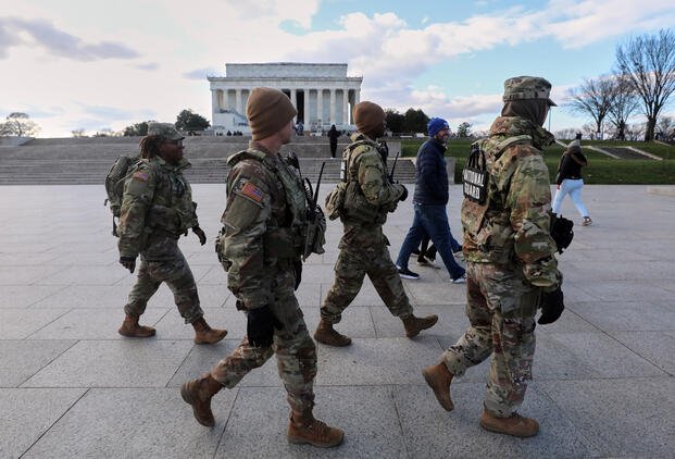 National Guard patrol the National Mall near the Lincoln Memorial.