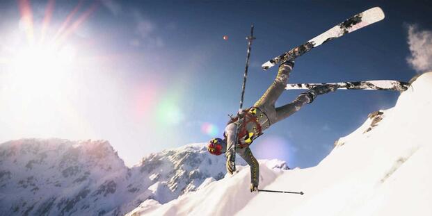 Jumping from a slope wearing skis in Steep