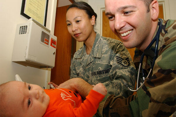 Staff Sgt. Lorylee Willis injects Pediarix into two-month old Sophia Grace Pellegrino, as her father, Dr. (Capt.) Peter Pelligrino, 71st MDG pediatrician, looks on. (U.S. Air Force photo by Staff Sgt. Brian Hill)