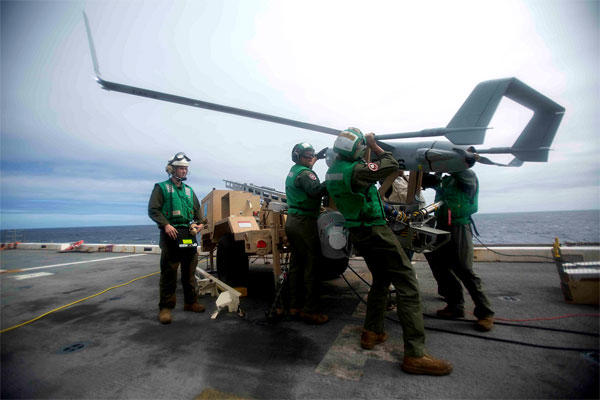 Marines load an RQ-21A Blackjack drone onto a launcher for its first shipboard operational flight July 5, on board the USS San Antonio (LPD 17), an amphibious transport dock ship. (US Marine Corps photo)