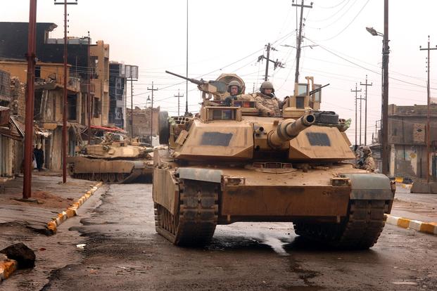 U.S. Army M1A2 Abrams tanks maneuver in the streets as they conduct a combat patrol in the city of Tall Afar, Iraq, on Feb. 3, 2005. DoD photo.