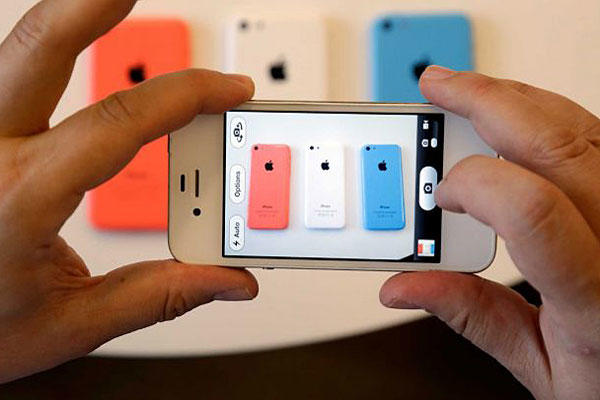 Apple debuts its new iPhones, which will come in a bevy of colors and two distinct designs, one made of plastic.