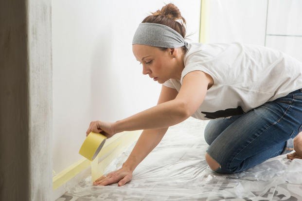 woman prepping to paint a wall