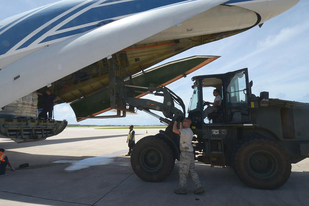 Airmen unload a cargo plane on Saipan
