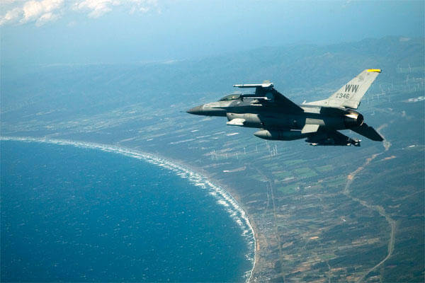 An F-16 Fighting Falcon flies over Misawa and Lake Ogawara on the way to a training mission May 13, 2009. (U.S. Air Force photo by 1st Lt. Ryan Cross)