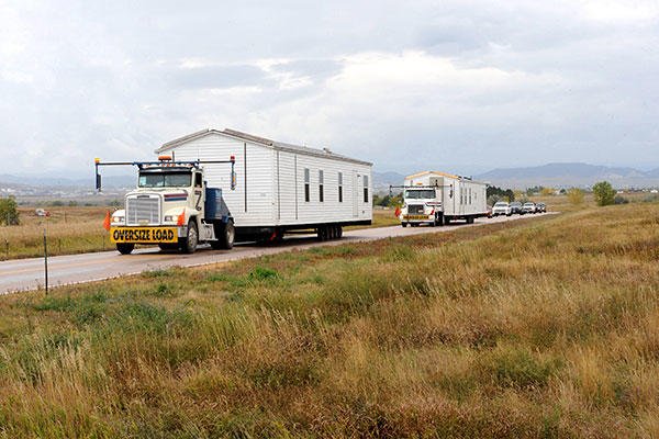 The first two manufactured housing units that are part of FEMA's response and recovery efforts related to severe storms and flooding on the Pine Ridge Indian Reservation arrived at Ellsworth Air Force Base Oct. 8, 2015. (U.S. Air Force/A1C Denise Nevins)