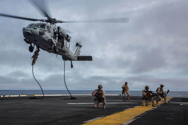 Marines and the Maritime Raid Force fast rope from a CH-60 Seahawk with Helicopter Sea Combat Squadron 23 aboard the USS Boxer off the coast of southern California during their Sustainment Exercise. (Photo: Sgt. Tyler C. Gregory)
