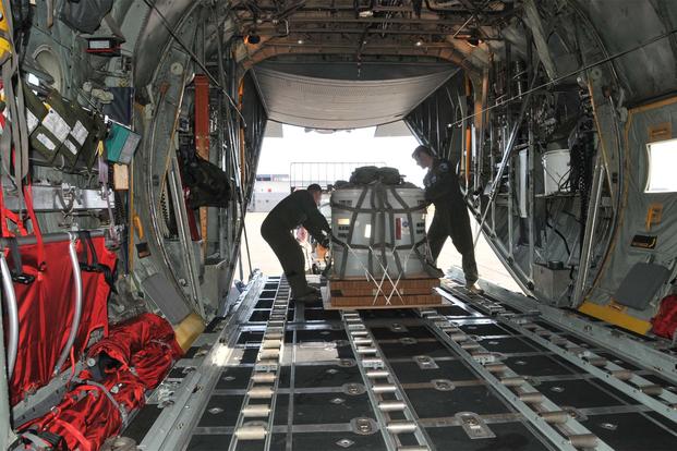 Loadmasters from the 186th Airlift Squadron secure a training cargo load aboard a Montana Air National Guard C-130 cargo aircraft. (U.S. Air National Guard/Tech. Sgt. Michael Touchette)