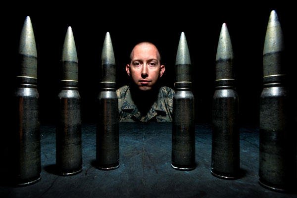 Tech. Sgt. Robert Kurz, the 20th Equipment Maintenance Squadron assistant first sergeant, stands behind training 20mm rounds at Shaw Air Force Base, S.C., April 28, 2015. (U.S. Air Force photo/Senior Airman Jensen Stidham)