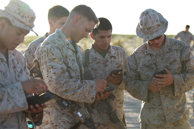 Marines with Fox Company, 2nd Battalion, 7th Marine Regiment use tablets to help them in a training exercise at Marine Corps Air Station Yuma, Arizona, Oct. 14, 2015. Photo By: Lance Cpl. David Staten